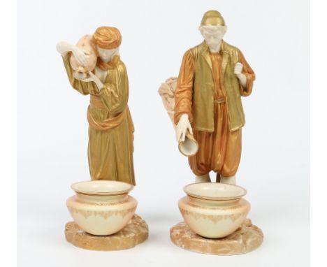 A pair of Royal Worcester figures modelled by James Hadley. Formed as a pair of Eastern water carriers each emptying a water 