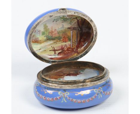 An early 19th century enamel bonbonniere with silver mount. Blue ground and decorated with roses, opening to reveal two topog