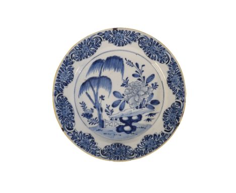 18TH CENTURY DELFTWARE CHARGER in blue and white, with a central chinoiserie scene, in a floral border