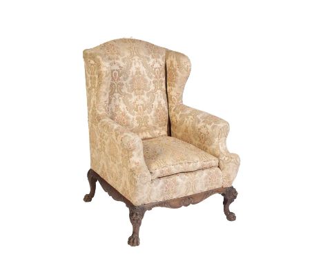 VICTORIAN WING BACK ARMCHAIR last quarter 19th century, in George II taste, with out swept arms, and heavily carved legs with