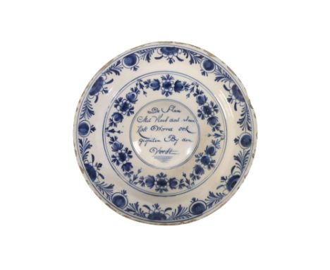 18TH CENTURY DELFTWARE CHARGER in blue and white, the central medallion with dutch script, with floral bordersÂ&nbsp;
