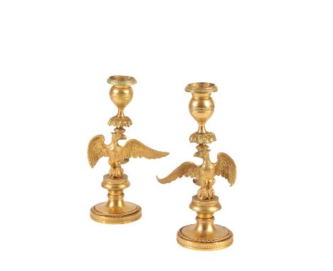 PAIR OF ORMOLU CANDLESTICKS CAST WITH SPREADEAGLES, EMPIRE OR POSSIBLY RUSSIAN early 19th century, the drip pans and urn sock