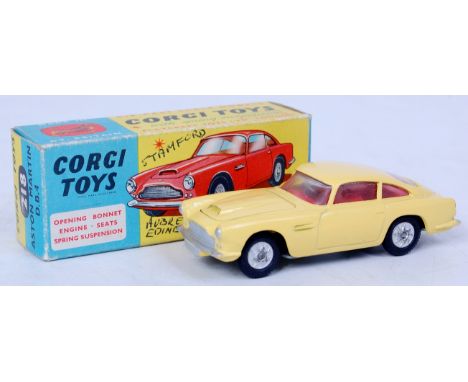 Corgi Toys, 218 Aston Martin DB4, yellow body with red interior, silver detailed grille with silver spoked cast hubs, in the 
