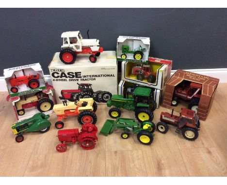 An Ertl Case four wheel drive tractor in its box together with thirteen further tractors by Ertl and othersCondition report: 