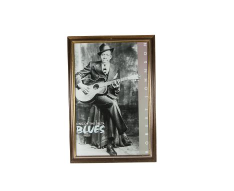 Robert Johnson, a framed and glazed poster:  'King of the Delta Blues' depicting Robert Johnson playing guitar (69cm x 99cm)