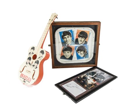 The Beatles,  a framed and glazed Beatles tray, a 1960s Selcol toy guitar has missing string and peg plus a crack at the base