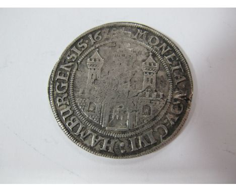 A 1628 Germany Hamburg Silver Thaler. Obverse is the triple-turreted gate of Hamburg, reverse shows the titles of Ferdinand I