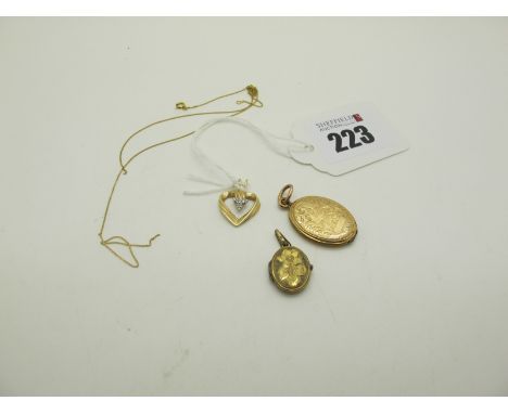 A Modern Heart Pendant, indistinctly stamped "14k", a fine chain and two oval locket pendants. 