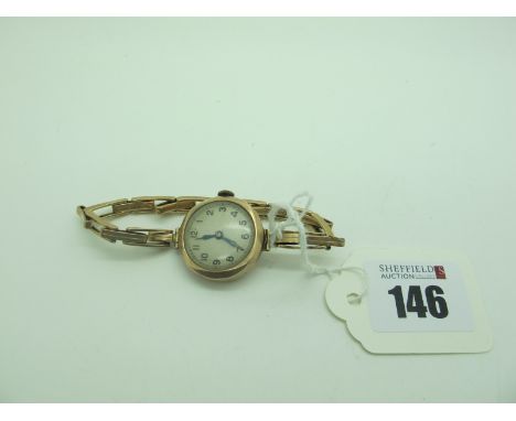 A 9ct Gold Cased Ladies Wristwatch, the unsigned dial with Arabic numerals, within plain case (dents), to integral sprung exp