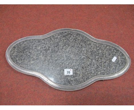 A Decorative XIX Century Plated Stand, with shaped granite panel (cracked), within textured and beaded border, raised on four