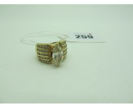 A Large Ornate Dress Ring, marquise claw set to the centre, high between wide channel set shoulders, indistinctly stamped "10