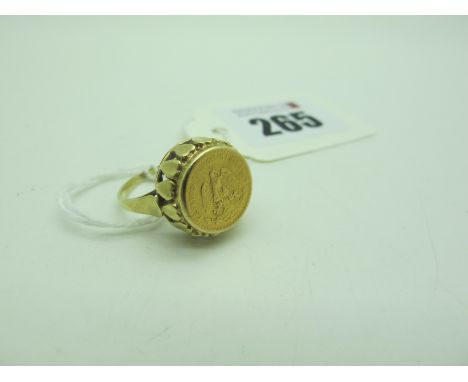 A Pesos Style Ring, within a high openwork heart shape setting, between plain shoulders stamped "585" (finger size M1/2) (4.5
