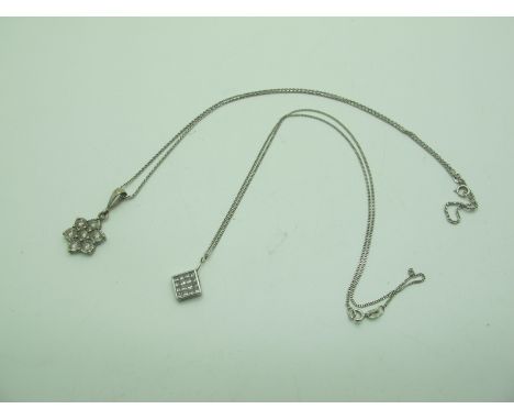 A 9ct White Gold Illusion Set Diamond Pendant, of flowerhead design, on fine chain stamped "750", another similar pendant of 