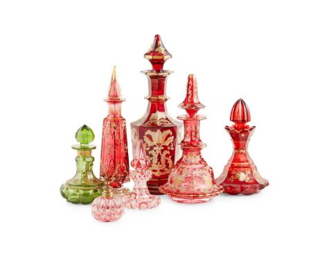 COLLECTION OF BOHEMIAN RUBY GLASS BOTTLES AND STOPPERS 19TH CENTURY comprising four of various forms decorated with gilt desi