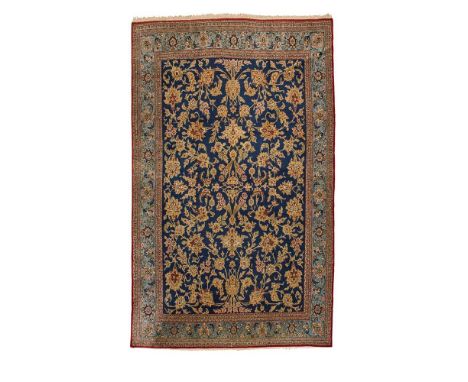 QUM CARPET CENTRAL PERSIA, MID 20TH CENTURY the indigo field with allover foliate pattern, within light blue borderDimensions