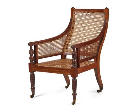 IRISH REGENCY MAHOGANY BERGÈRE EARLY 19TH CENTURY with caned back, seat and enclosed arms with spiral carved baluster support