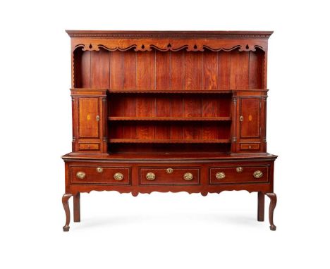 GEORGE III OAK DRESSER LATE 18TH CENTURY the upper part with a closed back and dentil moulded cornice above a pierced and wav