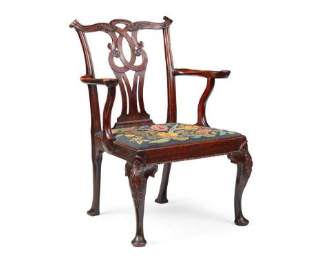 GEORGE III MAHOGANY ARMCHAIR, IN THE MANNER OF THOMAS CHIPPENDALE MID 18TH CENTURY of large size, the shaped top rail carved 