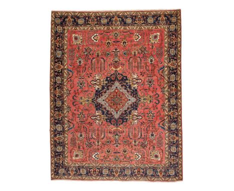 TABRIZ CARPET NORTHWEST PERSIA, EARLY/MID 20TH CENTURY the salmon pink field with indigo, light blue and rust medallion, with