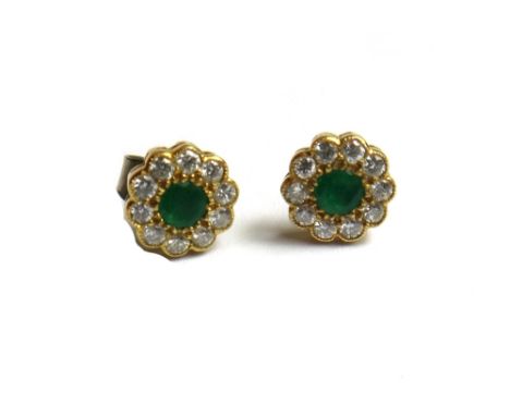 A pair of 18ct gold, emerald and diamond set cluster earstuds, each mounted with a circular cut emerald at the centre, within
