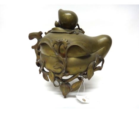 A large Chinese bronze censer, late 19th/20th century, modelled as a large peach, the branch handle curving around the body i