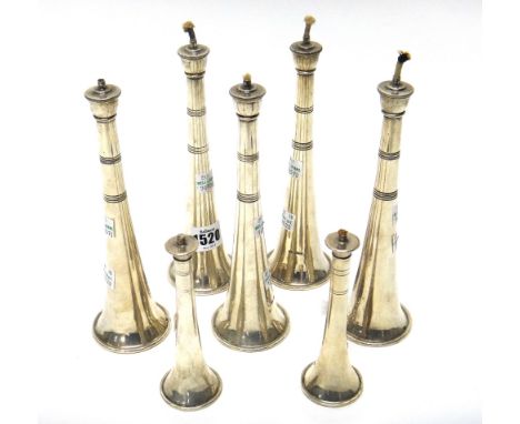 A set of five silver table lighters, Sheffield 1936, by Walker and Hall in the form of hunting horns, loaded bases and two ma