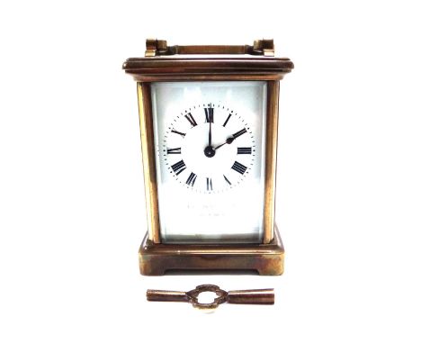A French brass cased carriage clock, early 20th century, with white enamel dial (indistinctly lettered) and a single train mo