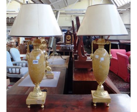 A pair of Louis XVI style marble and gilt metal mounted table lamps of classical urn form, each handle cast with portrait mas