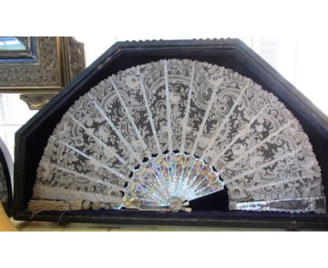 A Brussels lace fan, early 19th century, with gilt pierced foliate mother of pearl sticks, cased, and another painted paper a