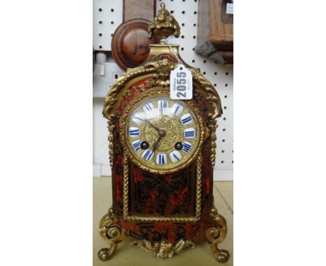 A Louis XIV style boullework mantel clock, late 19th century, with fruit comport finial over a shaped case, the relief cast m