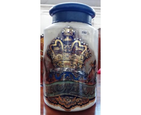 A large glass pharmaceutical jar and enamel cover, late 19th century, reverse painted and gilt with the inscription 'Arrow Ro