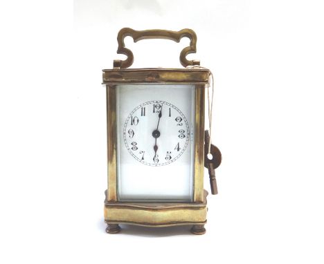 A gilt brass cased carriage clock, early 20th century, the shaped case set with an enamel dial and single train movement, on 