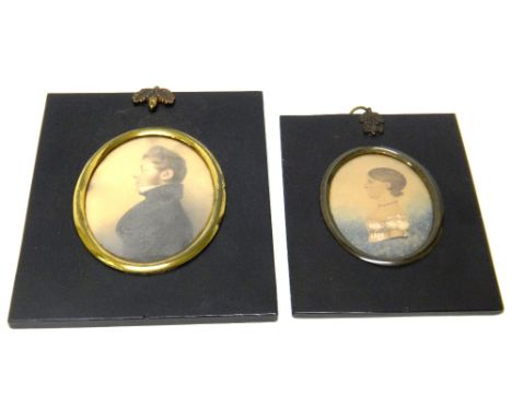 An oval portrait miniature of a gentleman, with curly brown hair, wearing a black coat and a smaller oval portrait miniature 