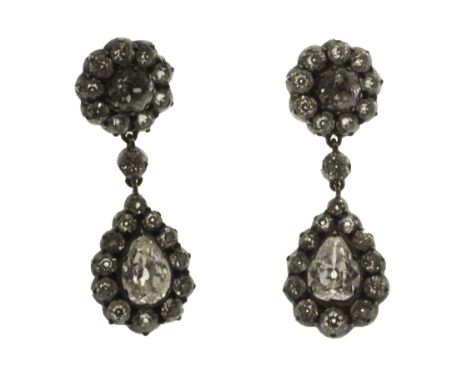 A pair of diamond set pendant earrings, each mounted with the principle pear shaped diamond to the drop, within a surround of