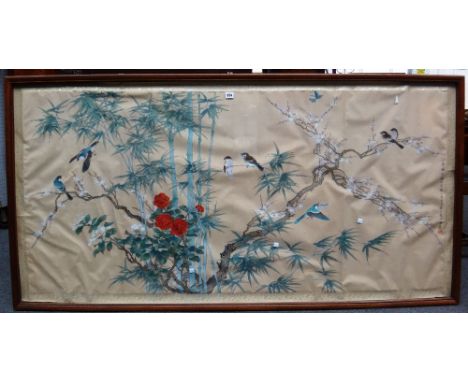 A large Chinese painting on silk, 20th century, painted with birds amongst flowering prunus, peony and bamboo, calligraphy to
