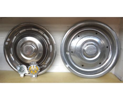 Automobilia; Bentley; a Smith electric wall clock with Bentley motif to glass, two hub cabs and three Bentley advertising pri