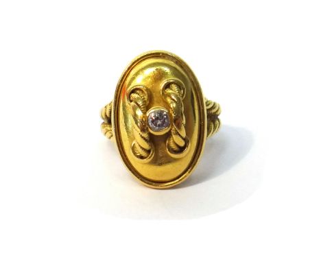 A Cartier gold and diamond set single stone ring, designed as a stylized oval button, with ropetwist decoration and collet se