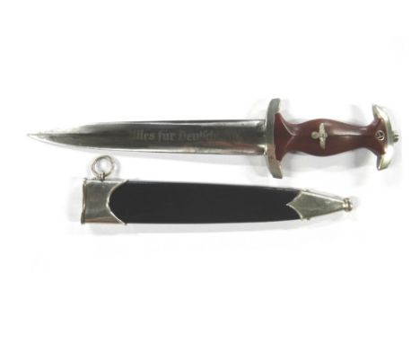 A German S.A. dagger, with double edged polished steel blade (21.7cm) engraved 'Illes fur Deutchland', the wooden handle with