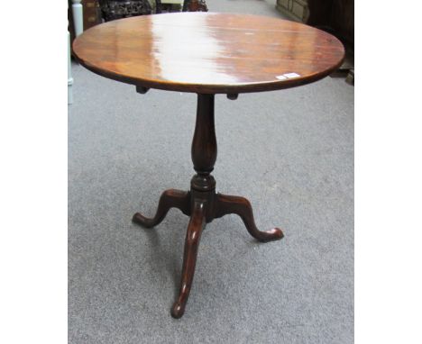 An 18th century oak circular snap top occasional table on tripod base, 73cm wide.