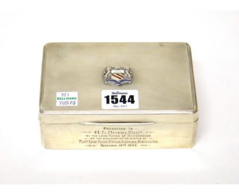 A rectangular silver cigarette box, Birmingham 1933, the engine turned cover applied with an enamel coat of arms, and inscrib