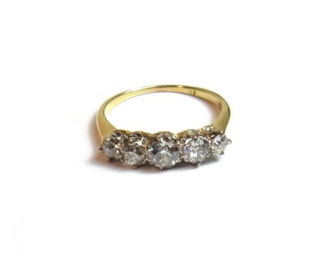 A gold and diamond set five stone ring, claw set with a row of cushion shaped diamonds, graduating in size to the centre ston