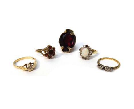 A gold ring, claw set with a row of four cushion shaped diamonds (the central fifth diamond lacking), a 9ct gold, opal and co