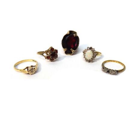 A gold ring, claw set with a row of four cushion shaped diamonds (the central fifth diamond lacking), a 9ct gold, opal and co