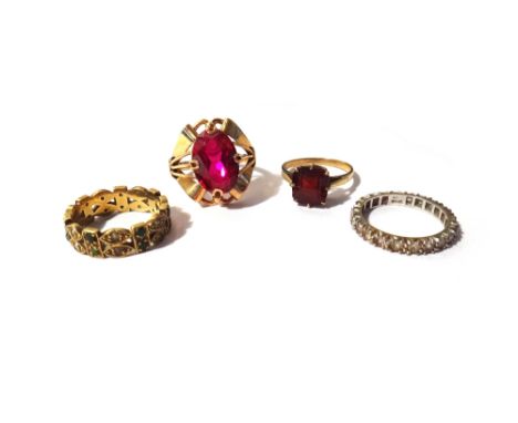 A Russian gold ring mounted with an oval cut synthetic ruby, a gold, seed pearl and turquoise set eternity ring, a white gold