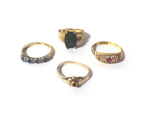 A gold and green tourmaline set single stone ring, an 18ct gold ring, mounted with two cushion shaped rubies and with two cus