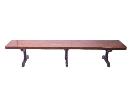 A massive elm and oak refectory table, the single slab elm top on three oak trestle standards, the top 90cm wide x 438cm long