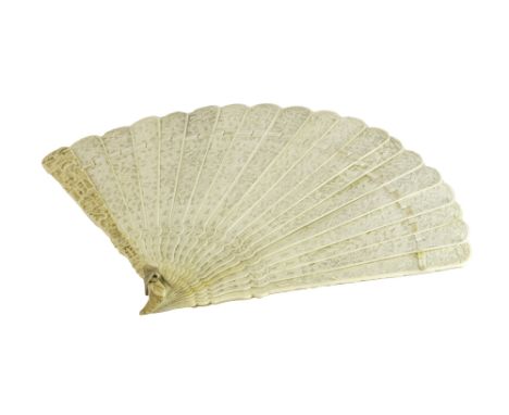 A Canton ivory brise fan, circa 1900 intricately carved with Oriental figures and foliate panels, stick guard, 20.5cm.   Illu