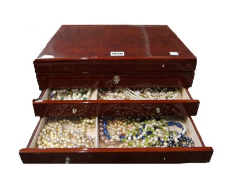 A collection of mostly costume jewellery, mostly freshwater cultured pearl and other necklaces, with a fitted jewellery cabin