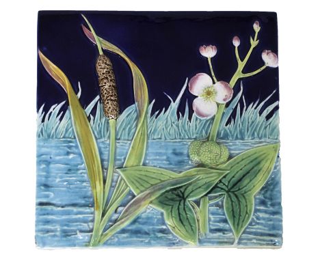 A George Jones majolica tile, late 19th century, moulded in high relief with bull rushes and prunus against a river and dark 