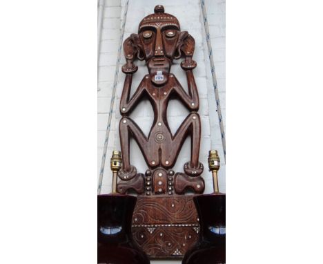 An African carved wooden fertility figure with mother of pearl inlay (96cm high), an Asian polychrome decorated carved wooden